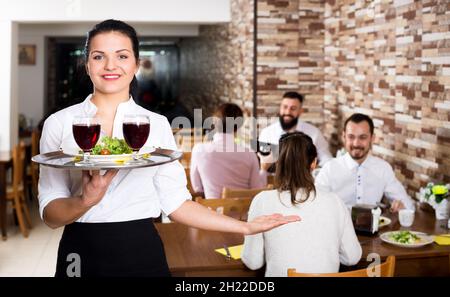 Female waiter showing country restaurant Stock Photo