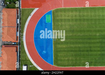 Aerial view of empty new soccer field from above with running tracks around it Amazing new small stadium for many sport disciplines at phuket thailand Stock Photo