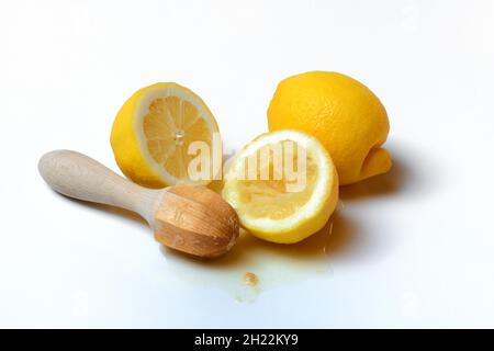 Lemons and lemon squeezer, squeezed lemon and lemon juice Stock Photo