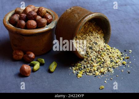 Dukkah, Arabic spice mixture in clay pots and nuts Stock Photo