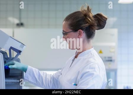 Young lab technician with lab glove and sample working in a lab with lab equipment, Freiburg, Baden-Wuerttemberg, Germany Stock Photo