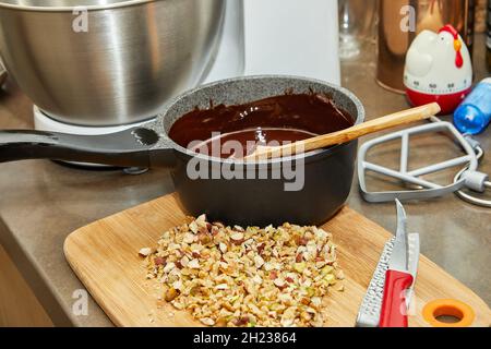 Chopped nuts and boiled chocolate are ready for cooking Stock Photo