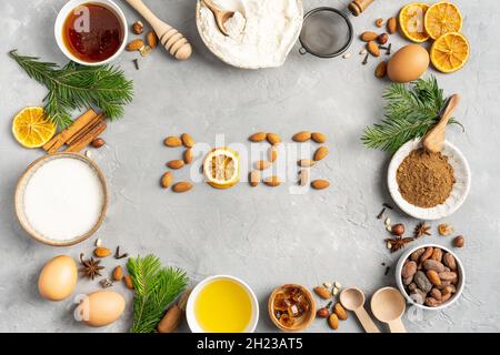 Frame of Ingredients for cooking Christmas baking and gingerbread cookies on a gray background, top view. New Year 2022, holidays Stock Photo