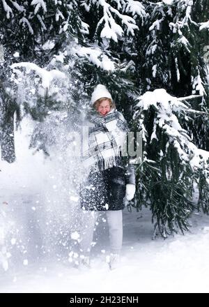 A man riding skis down a snow covered slope Stock Photo