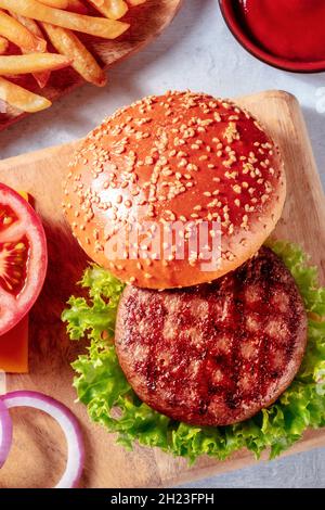 Beef patty with a burger bun, hamburger ingredients, a close-up shot from the top, delicious fast food Stock Photo