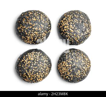Black bun. Dark pastry with sesame seeds isolated on white background. Stock Photo