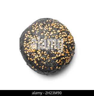 Black bun. Dark pastry with sesame seeds isolated on white background. Stock Photo