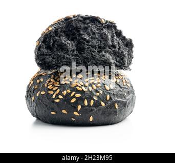 Black bun. Dark pastry with sesame seeds isolated on white background. Stock Photo