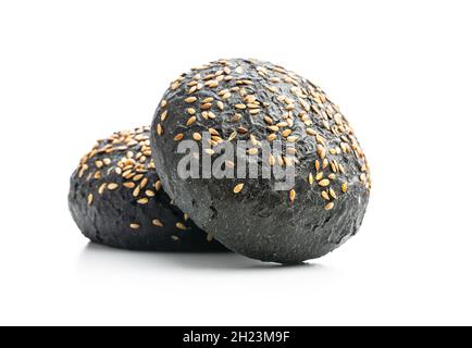Black bun. Dark pastry with sesame seeds isolated on white background. Stock Photo