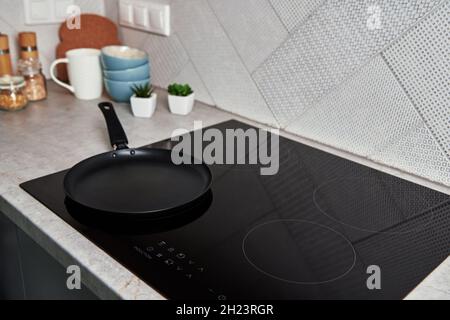 Modern kitchen appliance. Cooking pan on the surface of induction panel with sensor panel Stock Photo