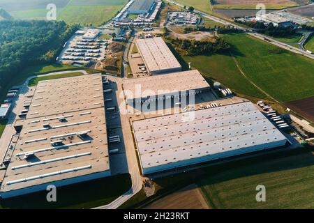 Parking lot for semi trucks near factory, top view. Aerial view of truck trailers parked for waiting loading on factory. Logistics and shipping Stock Photo