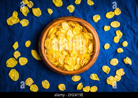 Tasty crispy corn flakes in bowl on the rustic background. Selective focus. Shallow depth of field. Stock Photo