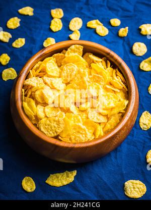 Tasty crispy corn flakes in bowl on the rustic background. Selective focus. Shallow depth of field. Stock Photo