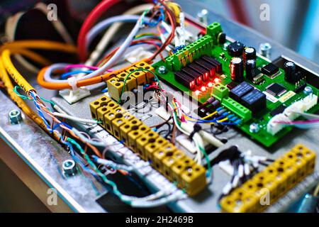 Electronic device with wires and chips close-up. Background Stock Photo