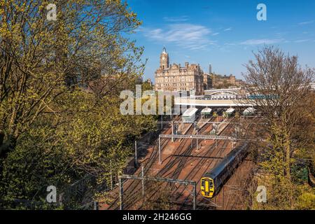 Edinburgh Waverley railway station with trains against Clock Tower building in Scotland, United Kingdom Stock Photo