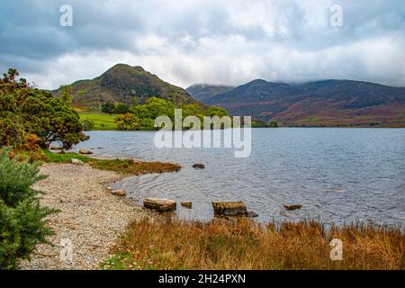 Serene Crummock Water, with Mellbeck and High Stile in the background on the way to Honnister Pass, Lake District National Park, Cumbria, England, UK Stock Photo