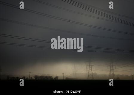 Electricity Pylons in the mist, Sizewell A and B Power Stations Stock Photo