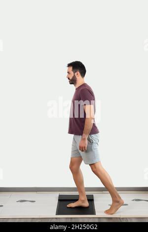 Patient performing an exercise to evaluate his stepping. Stock Photo