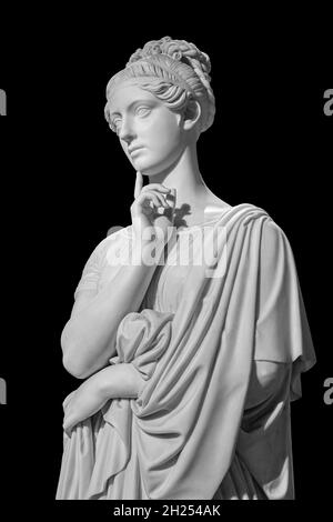 Gypsum copy of ancient statue of thinking young lady isolated on black background. Side view of plaster sculpture woman face Stock Photo