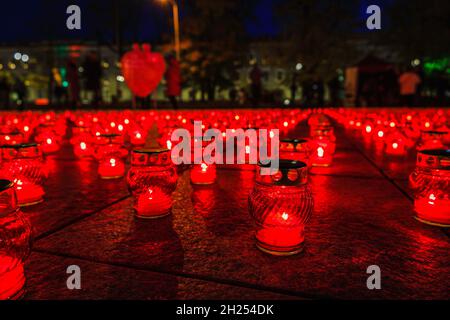 burning church candles in red transparent chandeliers Stock Photo