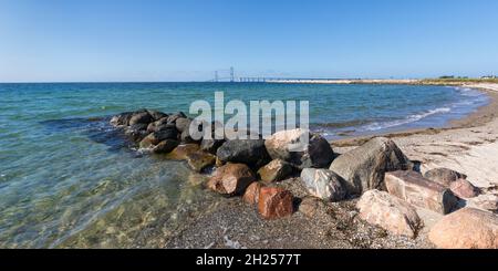 Panoramic view from Korsør to the East Bridge of Great Belt Fixed Link - Storebæltsbroen in Danish - beach and groyne in foreground Stock Photo