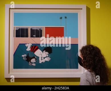 A visitor looks at an artwork by musician and founding member of The Specials Horace Panter, Spalsh, 2018, a reworking of David Hockney's 1967 painting A Bigger Spalsh, at Beano: The Art of Breaking the Rules, an exhibition of the world's longest-running weekly comic at Somerset House in London. Picture date: Wednesday October 20, 2021. Stock Photo