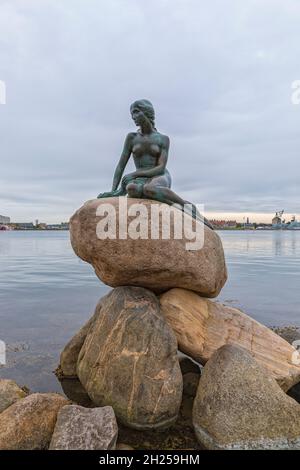 Copenhagen, Denmark, September 21, 2021: The Little Mermaid, statue by Edvard Eriksen after Hans Christian Andersens fairytale, on a pile of rocks in