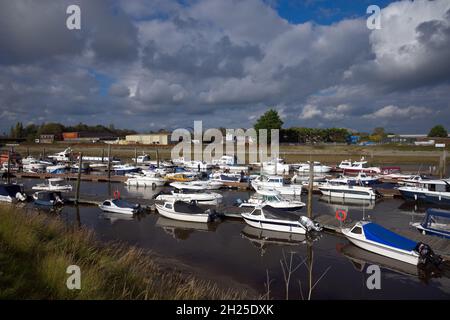 Footage of Littlehampton Marina with small leisure boats moored on jetty and reflecting in the calm water. Stock Photo