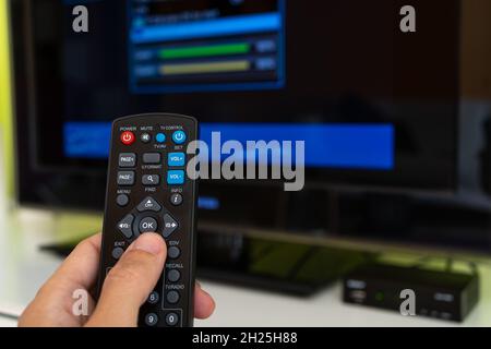 Digital decoder with remote control and television monitor. Stock Photo