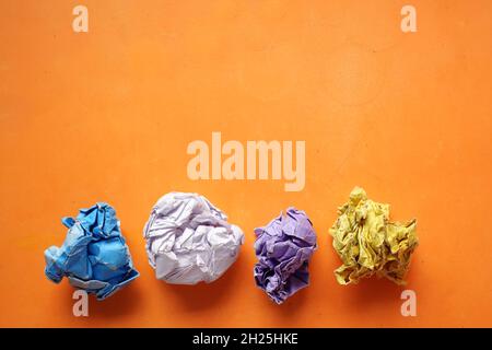top view of crumpled paper balls on orange background  Stock Photo