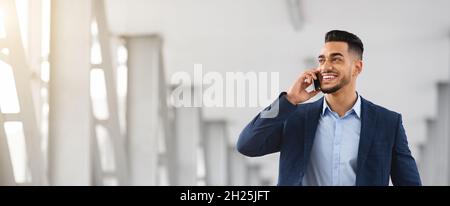 Business Call. Handsome Young Arab Man Talking On Mobile Phone Stock Photo