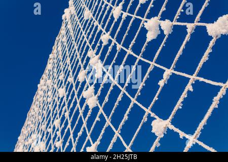 Volleyball net covered with snow. Nature's minimalism.  Stock Photo