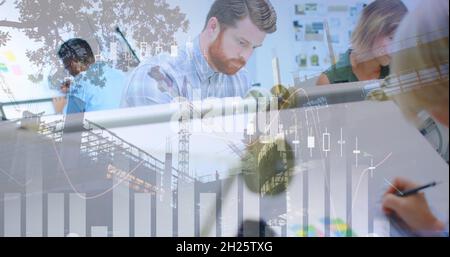 Graphs and architects drawing in an office and a building in construction Stock Photo