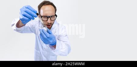 Flyer with young chemist, doctor wearing white gown conducts chemical research isolated on white background. Stock Photo