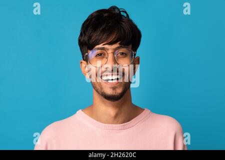 Closeup portrait of cheerful indian guy smiling at camera Stock Photo