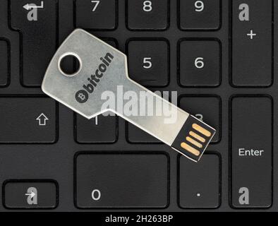 Key shaped flash disk inserted to a laptop. Concept of Cyber security on internet. Stock Photo