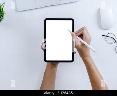hand using stylus pen on digital tablet Stock Photo