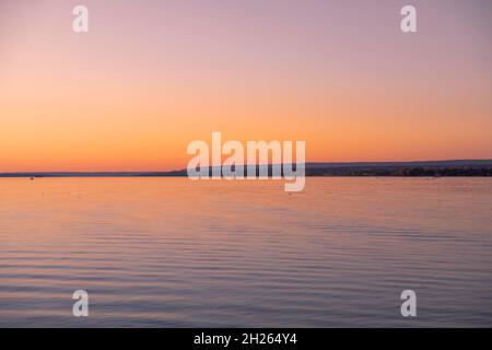 Beautiful sunrise reflecting on calm water Stock Photo