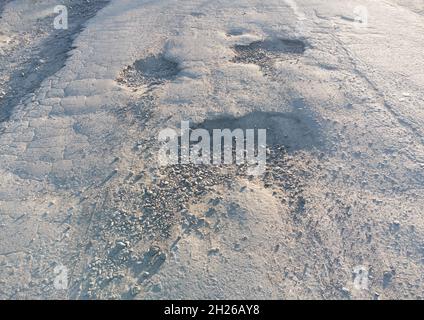 Pothole on the asphalt. Damaged road Stock Photo