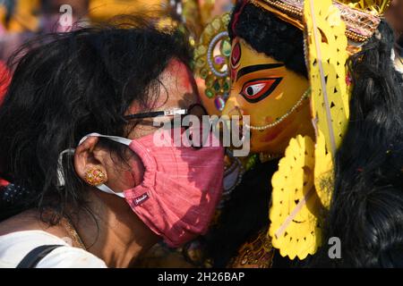 Durga idol immersion ceremony after the end of Durga Puja festival at the riverbank of the Ganges amid 2nd year of Covid-19 pandemic. The worship of G Stock Photo