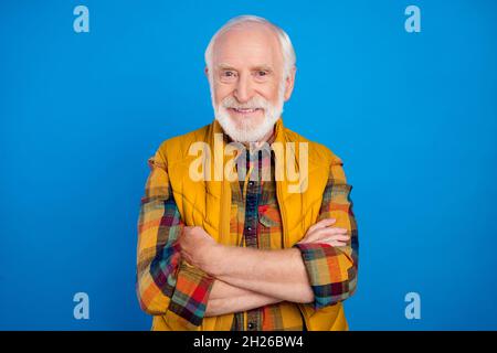 Portrait of attractive content cheery grey-haired man folded arms wearing checked shirt isolated over bright blue color background Stock Photo