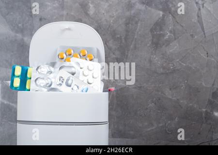 Expired pills collected in rubbish bin. Medicine recycle concept Stock Photo