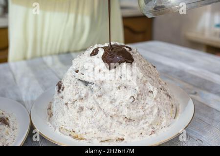 A step-by-step process for making a sour cream chocolate cake. The formed cake is poured with liquid chocolate icing. Stock Photo