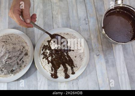 A step-by-step process for making a sour cream chocolate cake. The formed cake is poured with liquid chocolate icing. Stock Photo