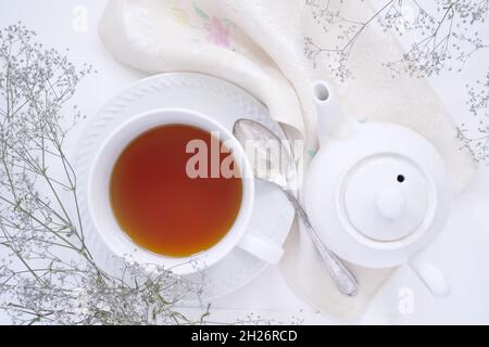 Top down view of a cup of tea and a teapot. Stock Photo