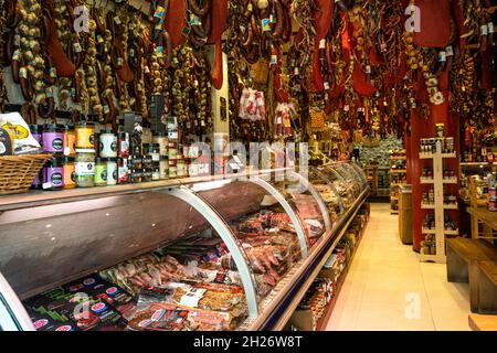meat and sauage store on Evripidou Street with hanging meat, garlic and spices hung from above Stock Photo