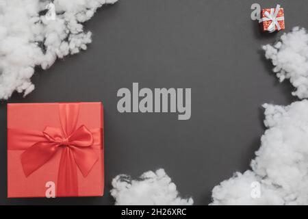 Composition with two red gift boxes of different sizes and white fiberfill between them Stock Photo
