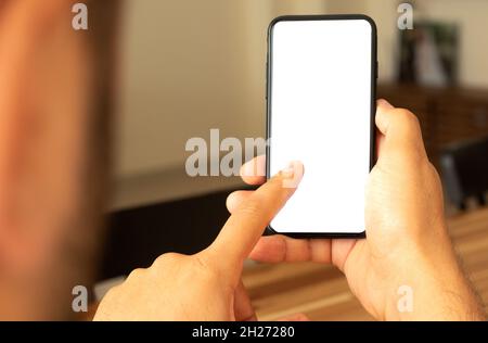 Man using smartphone as a screen mockup. Stock Photo