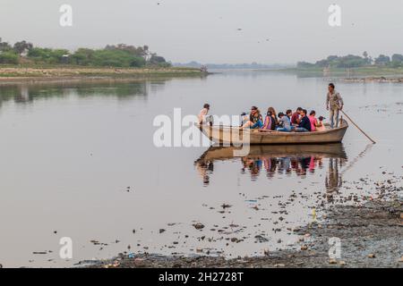 AGRA, INDIA - FEBRUARY 19, 2017: Tourists on a boat on Yamuna river observing Taj Mahal in Agra, India Stock Photo