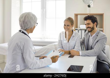 Young couple planning pregnancy and visiting professional medical specialist together Stock Photo